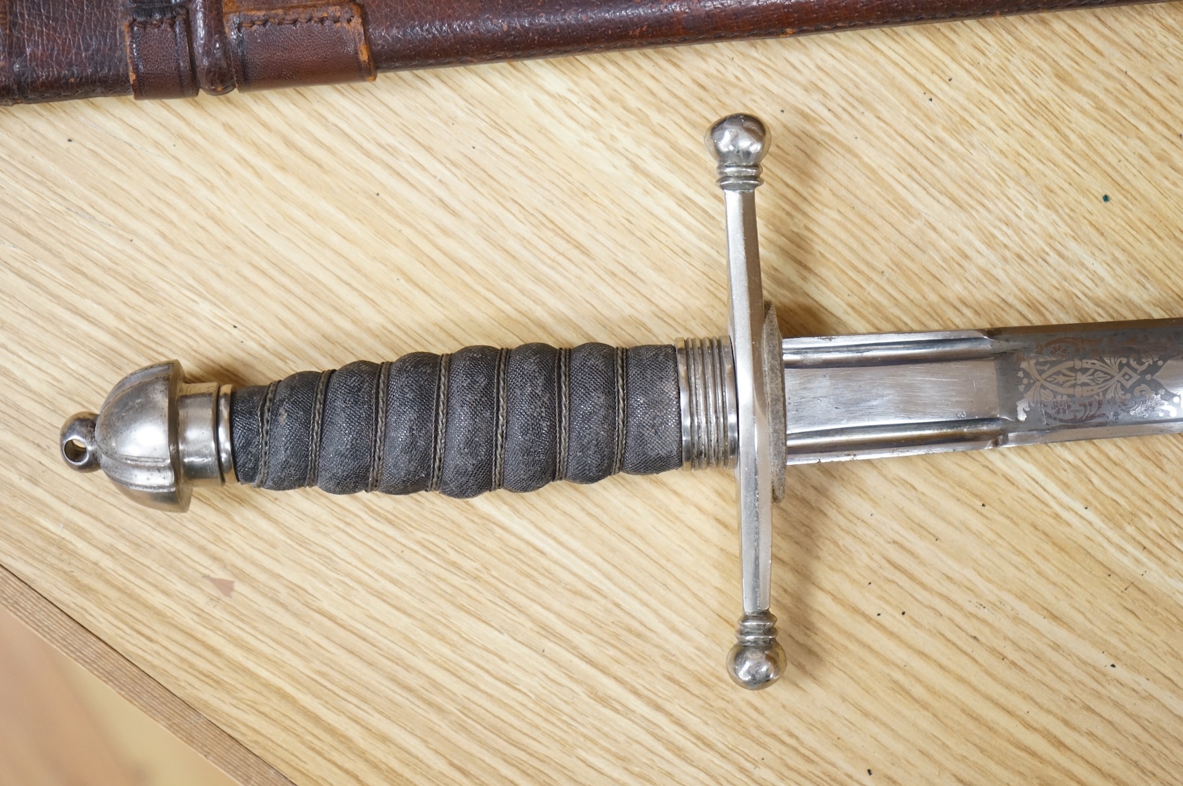 World War I Scottish infantry officer’s undress sword, etched and polished regulation blade with crowned GVR cipher and regulation cruciform hilt, in its leather scabbard